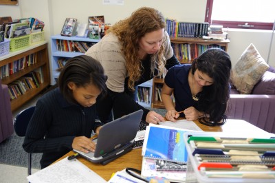 Sixth-graders work on writing projects with teacher Kim Albro 