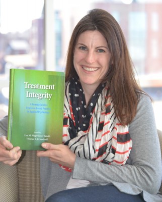 Lisa Sanetti proudly displays her new book.